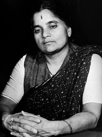 Photographic portrait of Durgabai Deshmukh seated with her hands folded.